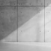Minimalist concrete wall with soft lighting.CREDIT_shutterstock_2520423781