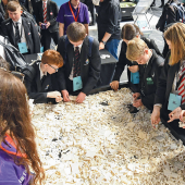 Students building with white LEGO bricks.Image credits | Alamy