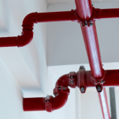 Red pipes on the ceiling.credit_istock-2175889477