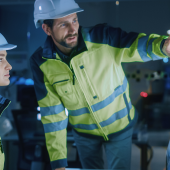 Project Engineer Talks to Female Operator who Controls Facility Production Line.shutterstock_1936528486