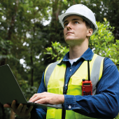 Engineer using laptop in a forest. CREDIT_shutterstock_2709356203