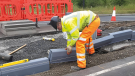 Construction worker installing road curb blocks.CREDIT_Phil-Sutton_Founder-of-Duraproducts