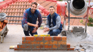 construction bricklayer men building brick wall. CREDIT_shutterstock_2440987653